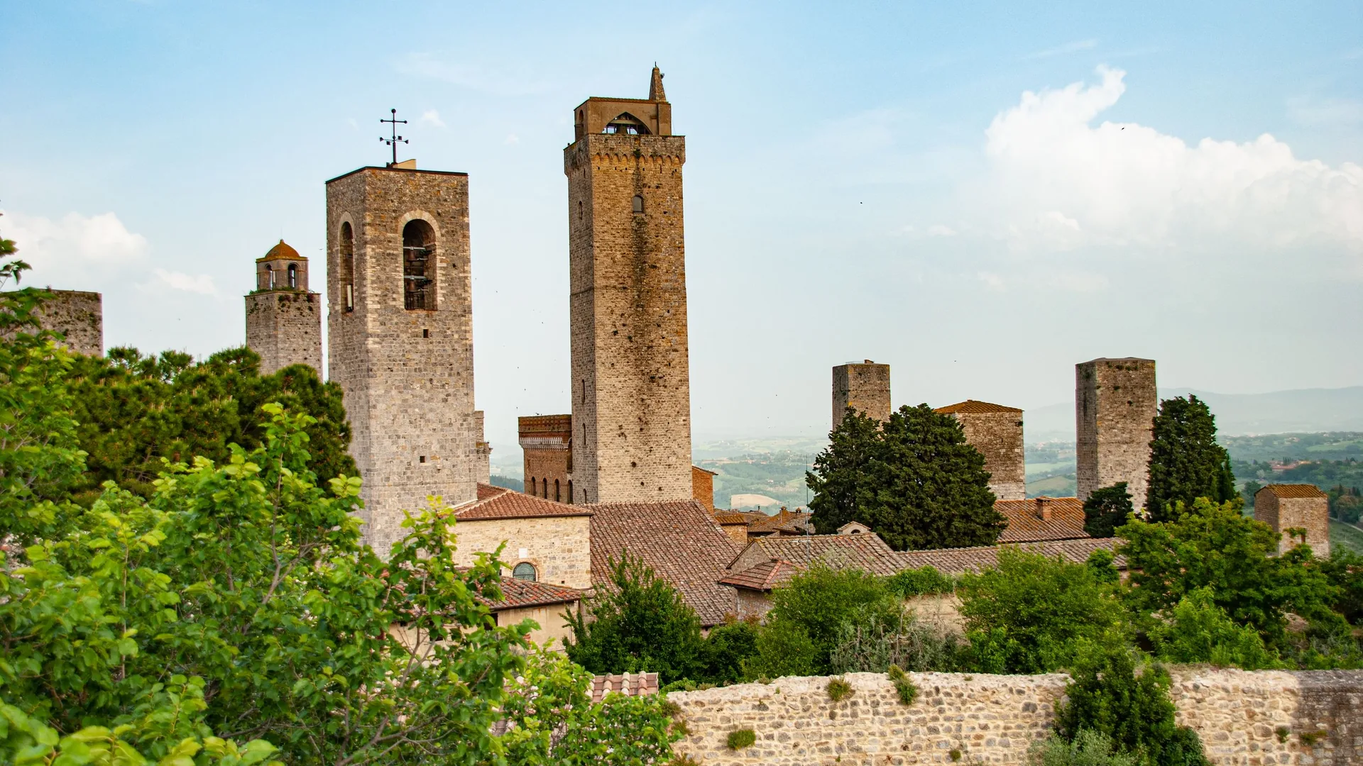 The medieval towers of San Gimignano rising above the Tuscan hills and vineyards